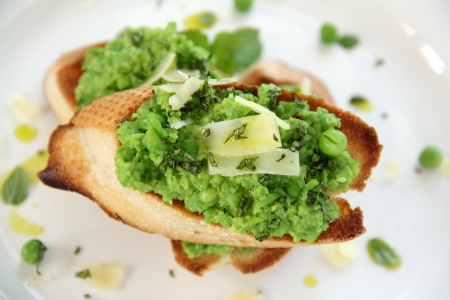 Delicious green pea baguettes with shaved cheese and mint with avocado oil.の写真素材