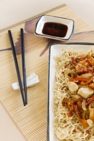 Chilli chicken stirfry with soy sauce condiments ready to serve.の写真素材