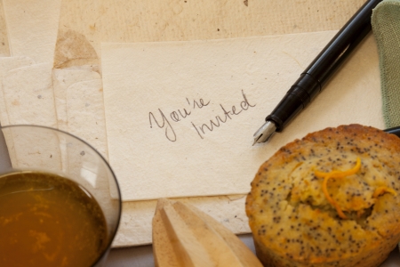 Invitation to afternoon tea with orange poppy seed cakes.の写真素材