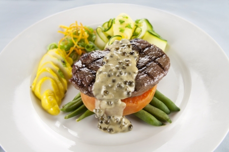 Chargrilled steak on sweet potato with green peppercorn sauce.の写真素材