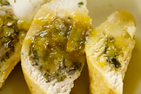 Delicious sliced stuffed chicken with a piquant sauce ready to serve.の写真素材