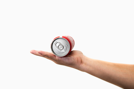 CHIANG RAI, THAILAND - APRIL 30TH, 2016. Holding a can of Coca Cola. Coca Cola drinks are produced and manufactured by The Coca-Cola Company, an American multinational beverage corporation.のeditorial素材