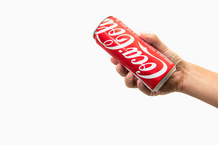 CHIANG RAI, THAILAND - APRIL 30TH, 2016. Holding a can of Coca Cola. Coca Cola drinks are produced...