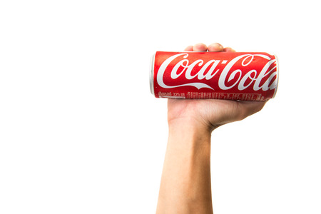 CHIANG RAI, THAILAND - APRIL 30TH, 2016. Holding a can of Coca Cola. Coca Cola drinks are produced and manufactured by The Coca-Cola Company, an American multinational beverage corporation.のeditorial素材