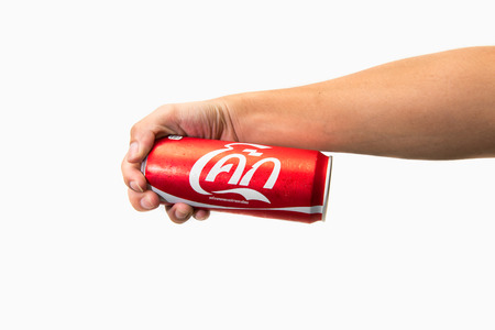 CHIANG RAI, THAILAND - APRIL 30TH, 2016. Holding a can of Coca Cola. Coca Cola drinks are produced and manufactured by The Coca-Cola Company, an American multinational beverage corporation.のeditorial素材