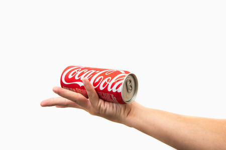 CHIANG RAI, THAILAND - APRIL 30TH, 2016. Holding a can of Coca Cola. Coca Cola drinks are produced and manufactured by The Coca-Cola Company, an American multinational beverage corporation.のeditorial素材
