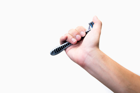 Hand with shaving razor on a white backgroundの写真素材