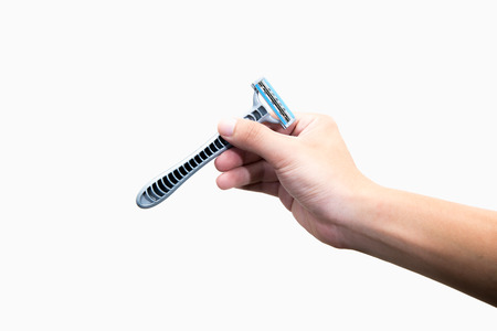 Hand with shaving razor on a white backgroundの写真素材