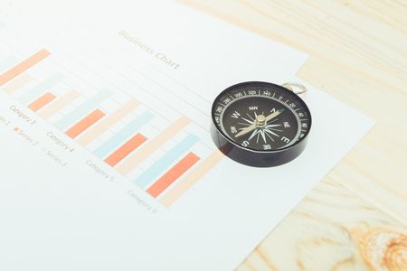 business navigation concept with compass and diagram or graphの写真素材