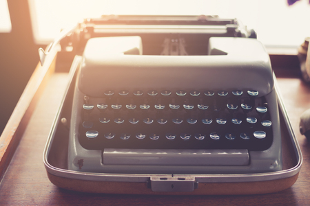 Vintage typewriter on a wood table , process in vintage styleの写真素材