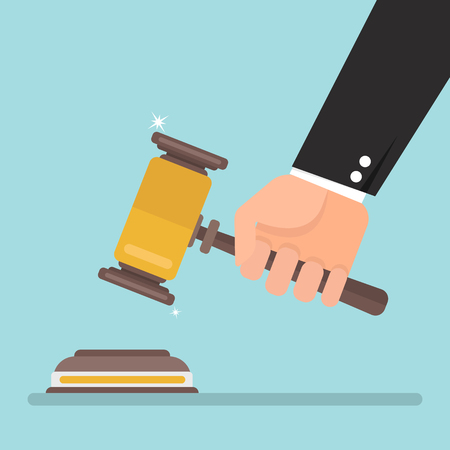 Hand holding judges gavel vector illustration in flat design on blue background, justice concept.のイラスト素材