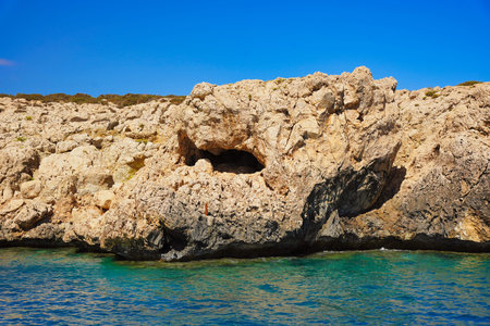 A rocky shore of the island resembling the shape of a monkey's head or something similar.の写真素材