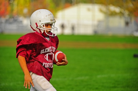 October 22, 2011 American Football (Youth 3-4th Grade) Hillsboro Oregon Century HS V Hillsoboro Oregon Glencoe HS.  Glencoe Viking slows down to a walk after his 40 yard sprint for one of his teams touch downs for this game.  Score not kept.のeditorial素材