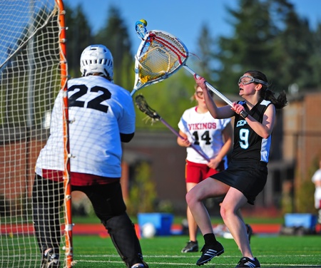 April 22, 2011 OGLA (OR Girls Lacrosse) Hillsboro OR Century HS Jaguars Varsity V Forest Grove HS Vikings. Century Jag Sophmore #9 Clarrissa Boggs tries to keep the ball from falling into the Vikings goalie grasp.  Final score 13-1 Century.のeditorial素材