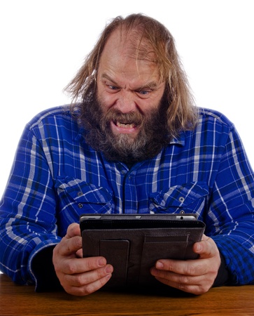 Man upset with tablet computerの写真素材