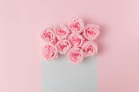 Flower arrangement of pastel pink roses with white copy space. Romantic layout.の写真素材