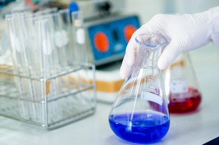 Test-tubes with solutions blood in hand of scientistの写真素材