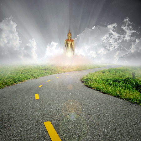 buddha in sunrise on the roadの写真素材