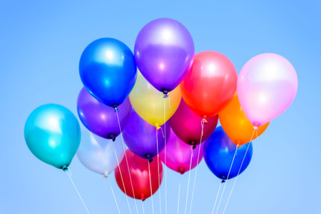 colorful balloons in blue sky and cloudsの写真素材
