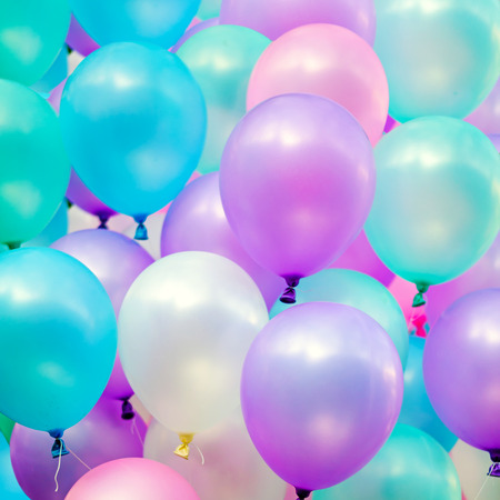colorful balloons in blue sky and cloudsの写真素材