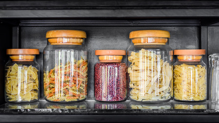 Glass jar filled with various pastaの写真素材