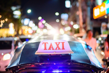 Tuk-Tuk Taxi sign with defocused lights blur , Chiang Mai, Thailandの写真素材