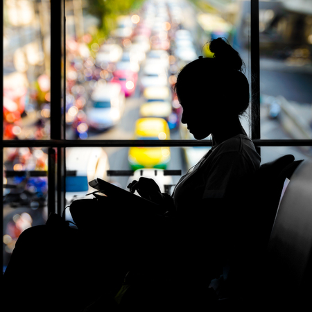 silhouette of Woman at airport with traffic jam backgroundの写真素材