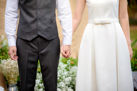 Bride and groom holding hands , vintage wedding ceremonyの写真素材