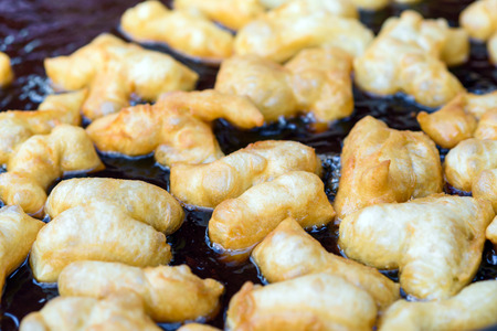 Deep frying Chinese bread stick in hot oilの写真素材