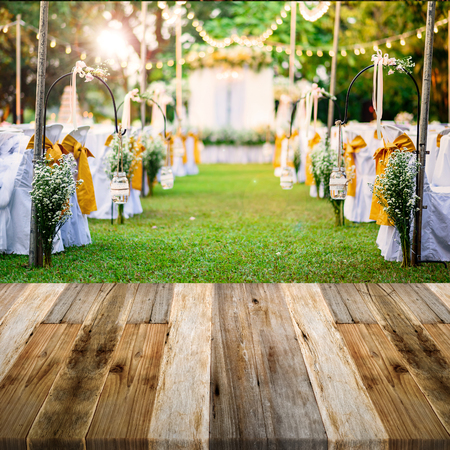 Beautiful Wedding ceremony in garden at sunset with wooden floor perspectiveの写真素材