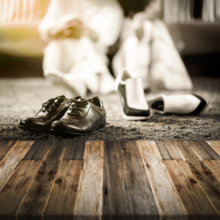 Wedding groom and bride shoes with married couple on luxury bed background with wooden floorの写真素材