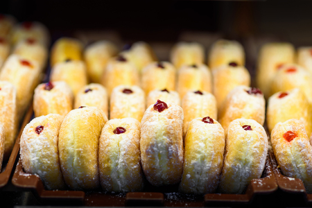 Close up view of donuts with berry jam pattern on dark backgroundの写真素材