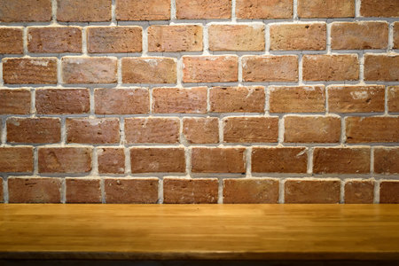 Empty top old wooden table and red brick walls backgrounds for text and background or put product