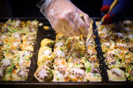Close up hand process to cooking takoyaki most popular delicious snack of japanの写真素材