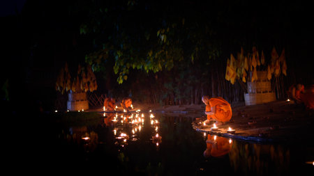 CHIANG MAI, THAILAND - May 18:  Visakha Puja Day Thai monks sitting meditate with many candle at Phan Tao temple  on May 18, 2019 in Chiang Mai, Thailand.のeditorial素材