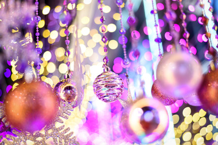 Colorful Baubles and Balls hanging decorated on christmas tree with bokeh light background