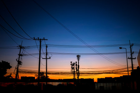 silhouette eletrical cable on electricity pole at  twilight dawnの写真素材