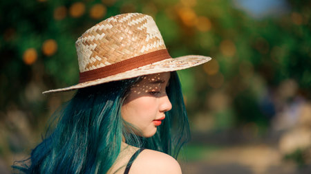 happy asian woman greeny hair in organic orange plantation gardenの写真素材