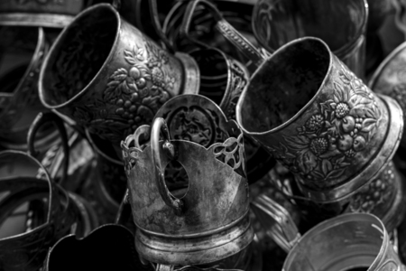 Vintage silverware, very old rich decorated style metal glass holder with empty glassの写真素材