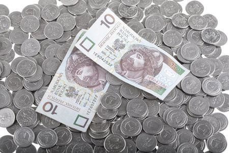 Ten polish zloty paper money laying on one polish zloty coins  Money and savings concept 