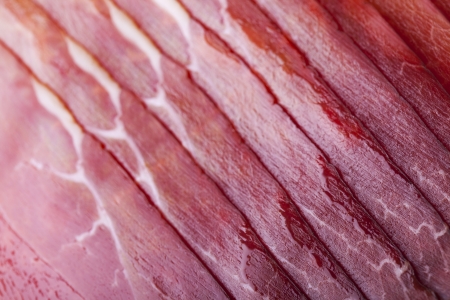 Tasty black forest ham slices. Closeup of smoked meat.の写真素材