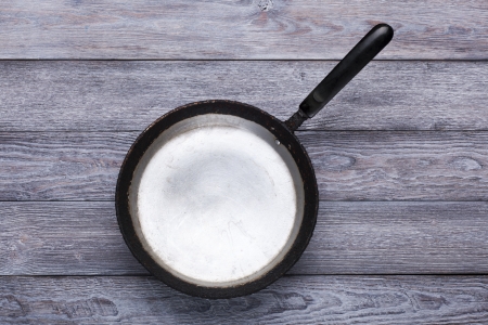Old vintage frying pan on white wooden table  Kitchen concept の写真素材