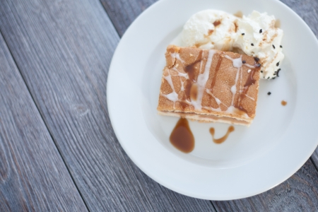 Fresh baked apple cake served with whipped cream and vanilla icecream. Homemade dessert decorated with sweet sauce and frosting.の写真素材