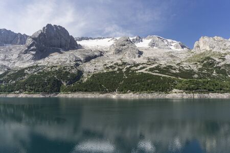 Lago di Fedaia beautiful lake on the background of the Marmolada massif.の写真素材