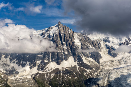 The beautiful scenery of the Aiguille du Midi and the glacier between the clouds. Mont Blanc massif.の写真素材