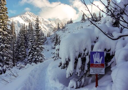 Landscape with a sign warning of the danger of avalanches. Tatryの写真素材