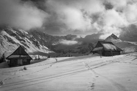 Old huts in the winter in the Polish Tatra Mountains. Gasienicowa Valley.の写真素材