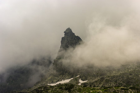 Peak of Monk among the mist. High Tatra mountains. Poland.