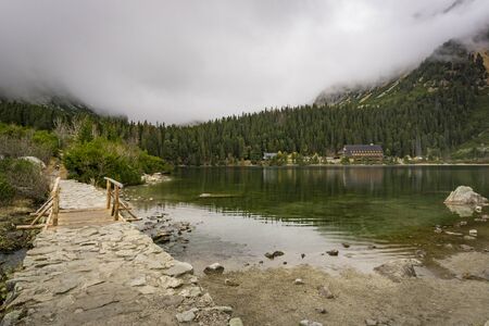 Foggy autumn landscape at the Popradske Pleso lake. High Tatras. Slovakia.の写真素材