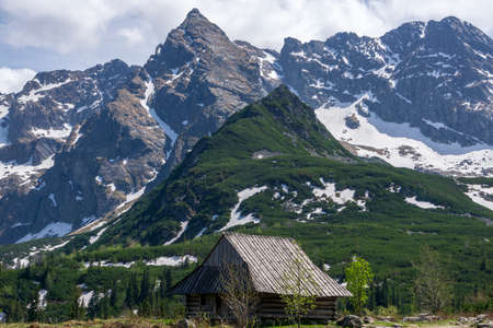 An old hut in the background of the Koscielec peak. Gasienicowa Valley. Tatra Mountains.の写真素材